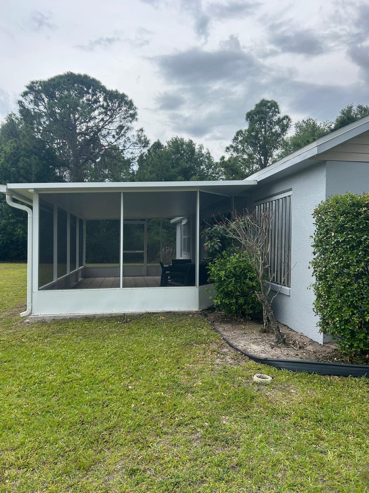 Residential exterior and screened patio before coating work