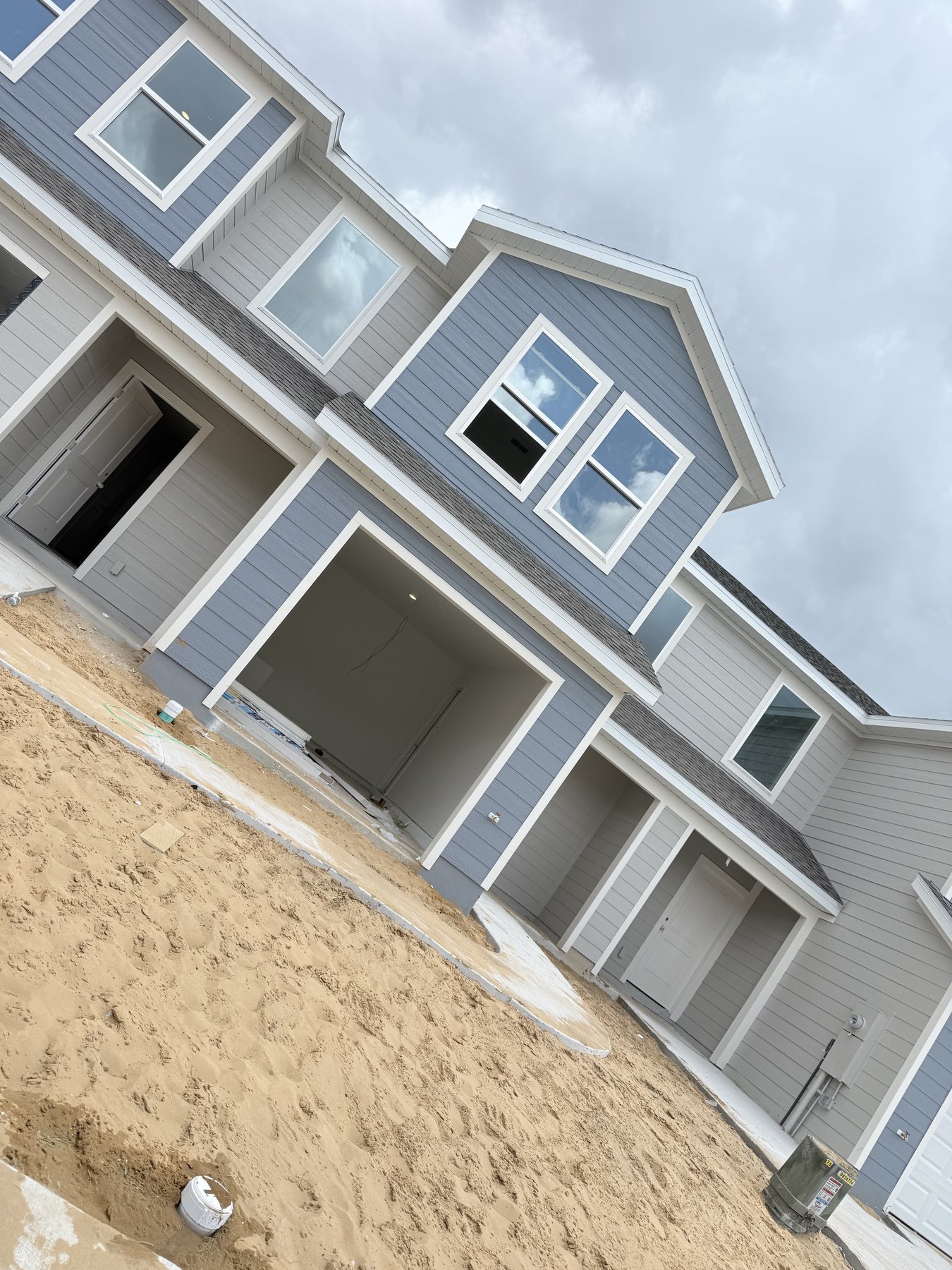 Two story home exterior painting project in progress